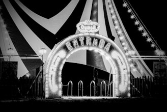 a black and white photo of a carnival entrance