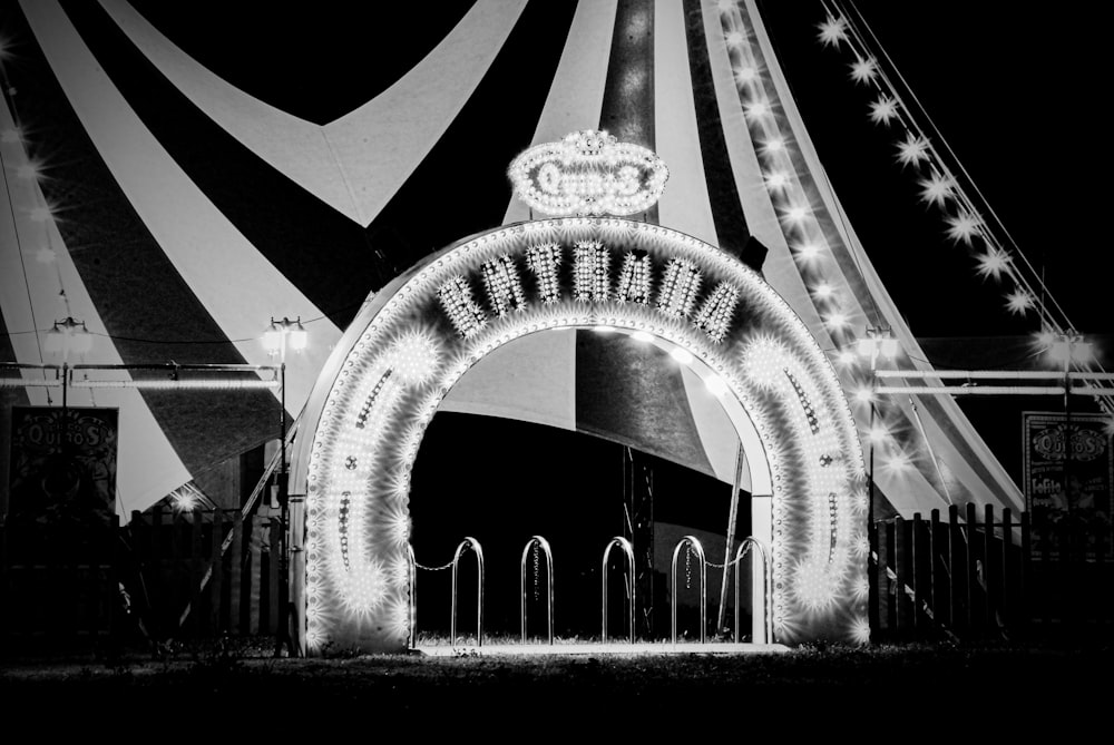 a black and white photo of a carnival entrance