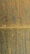 A textured surface with a blend of rust and yellowish hues creates a weathered appearance. The rust stains form irregular patterns and vertical streaks across the surface, evoking an aged and industrial look.
