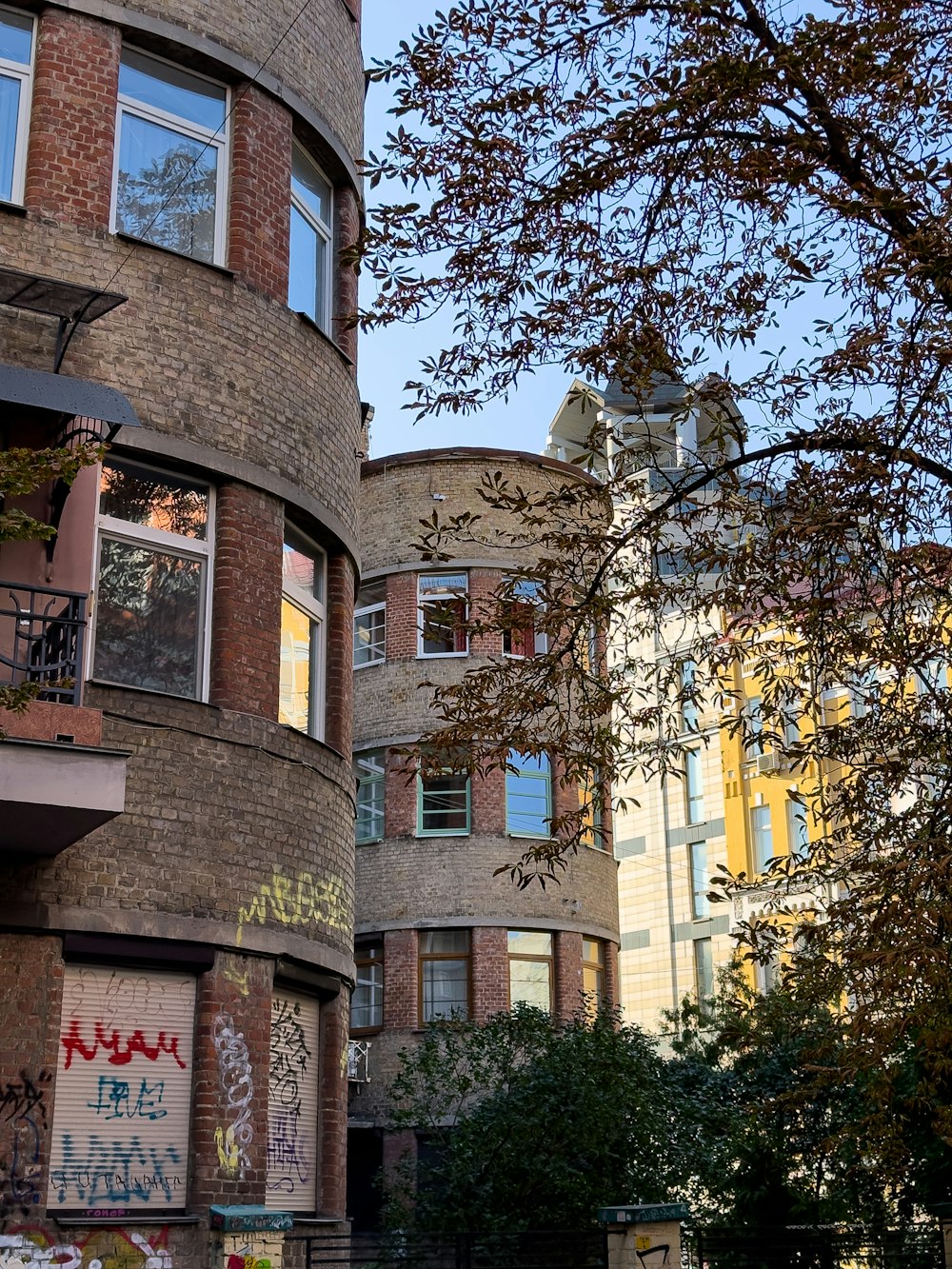 a tall brick building with graffiti all over it