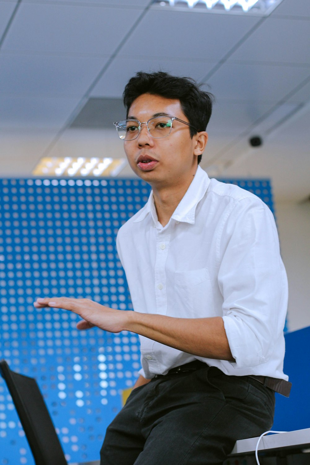 a man in a white shirt and black pants