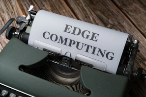 a close up of a typewriter with a paper reading edge computing