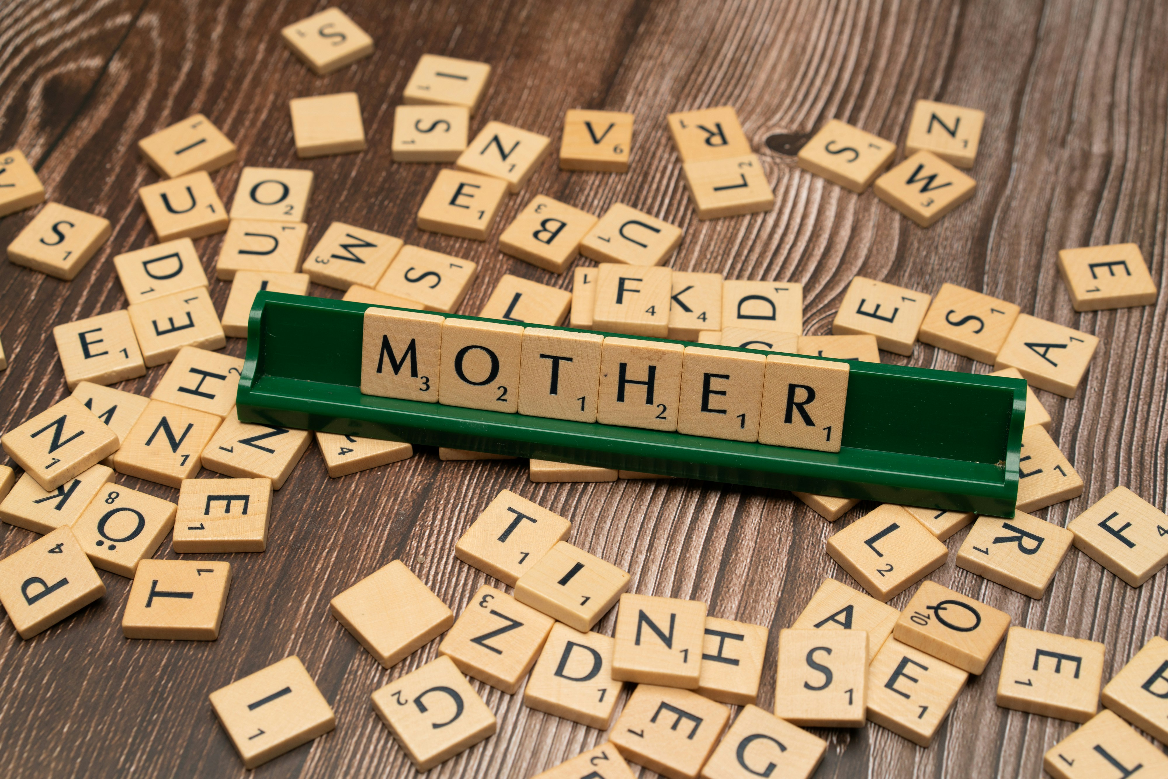 scrabble tiles spelling out the word mother