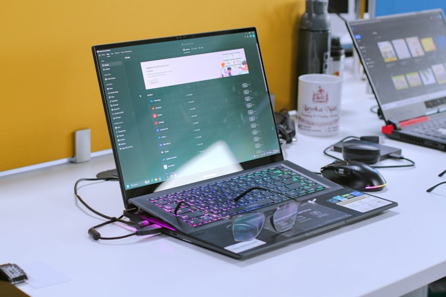 a laptop computer sitting on top of a white desk