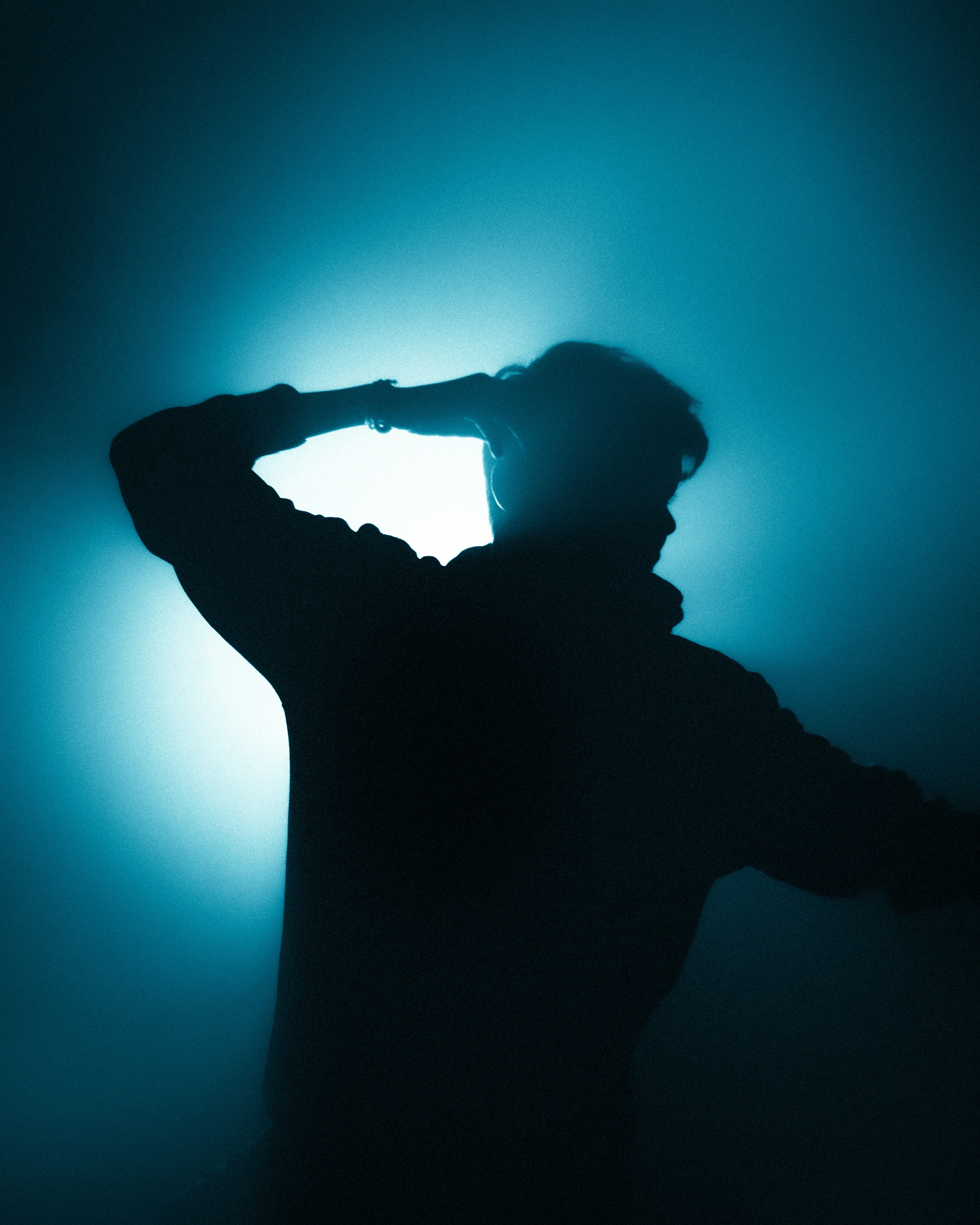 a silhouette of a man holding a baseball bat