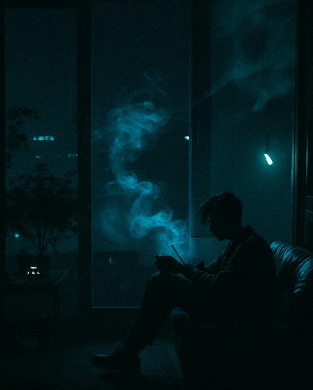 a man sitting on a couch in a dark room