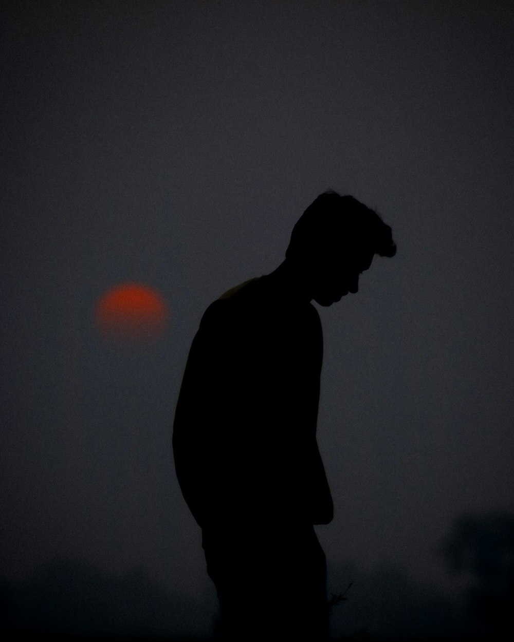 a silhouette of a man standing in the dark