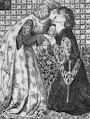 An intricately detailed black and white illustration of two people sharing a tender kiss. One person kneels while holding hands with the other, both dressed in medieval attire. The background features a pattern of hearts and circles.