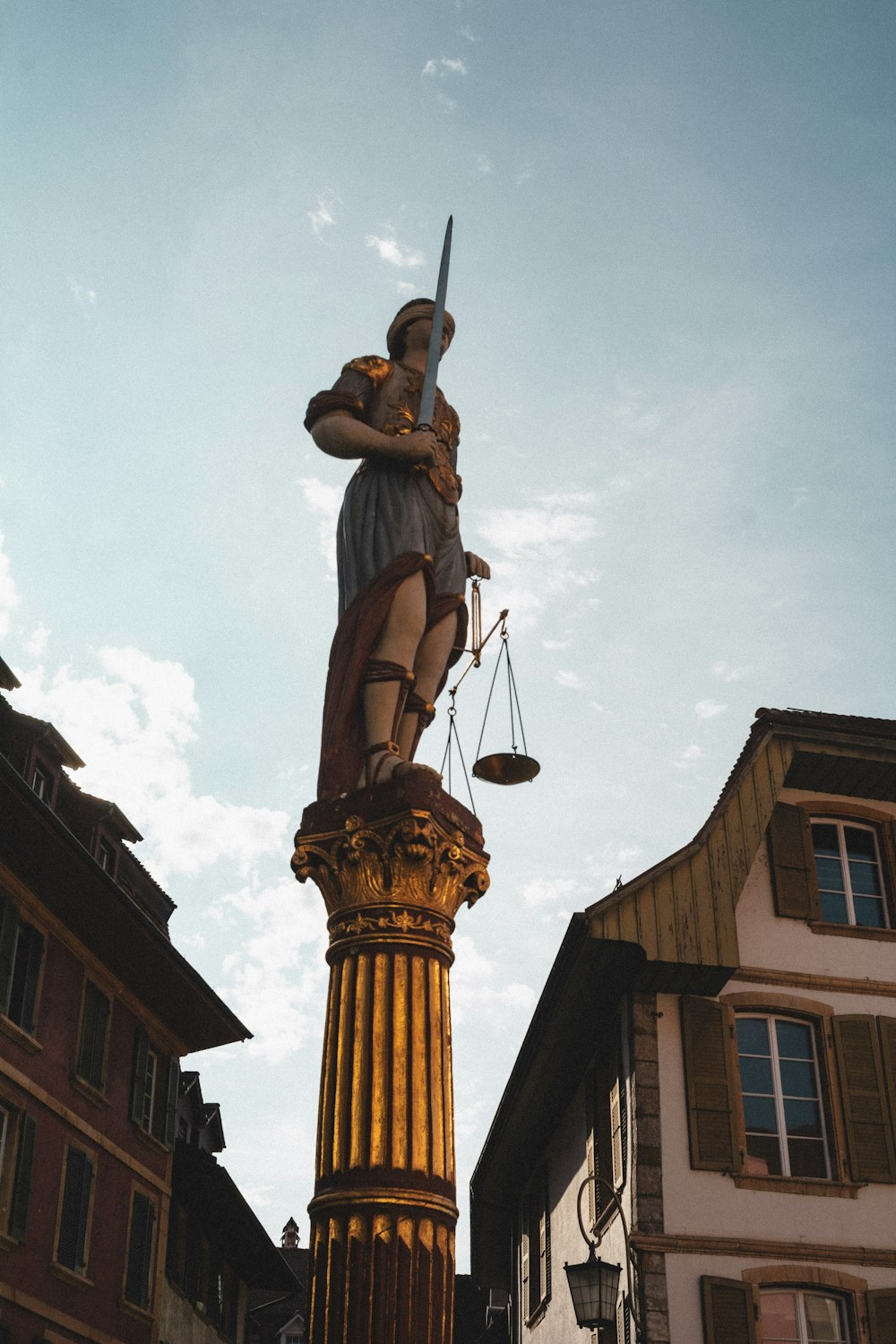 a statue of a lady justice holding a sword