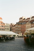 A charming European old town square with cobblestone streets and outdoor cafés.