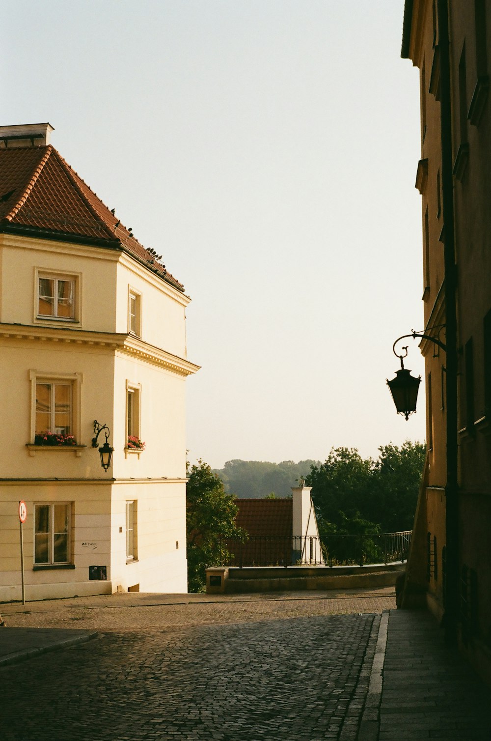 a cobblestone street with a building in the background