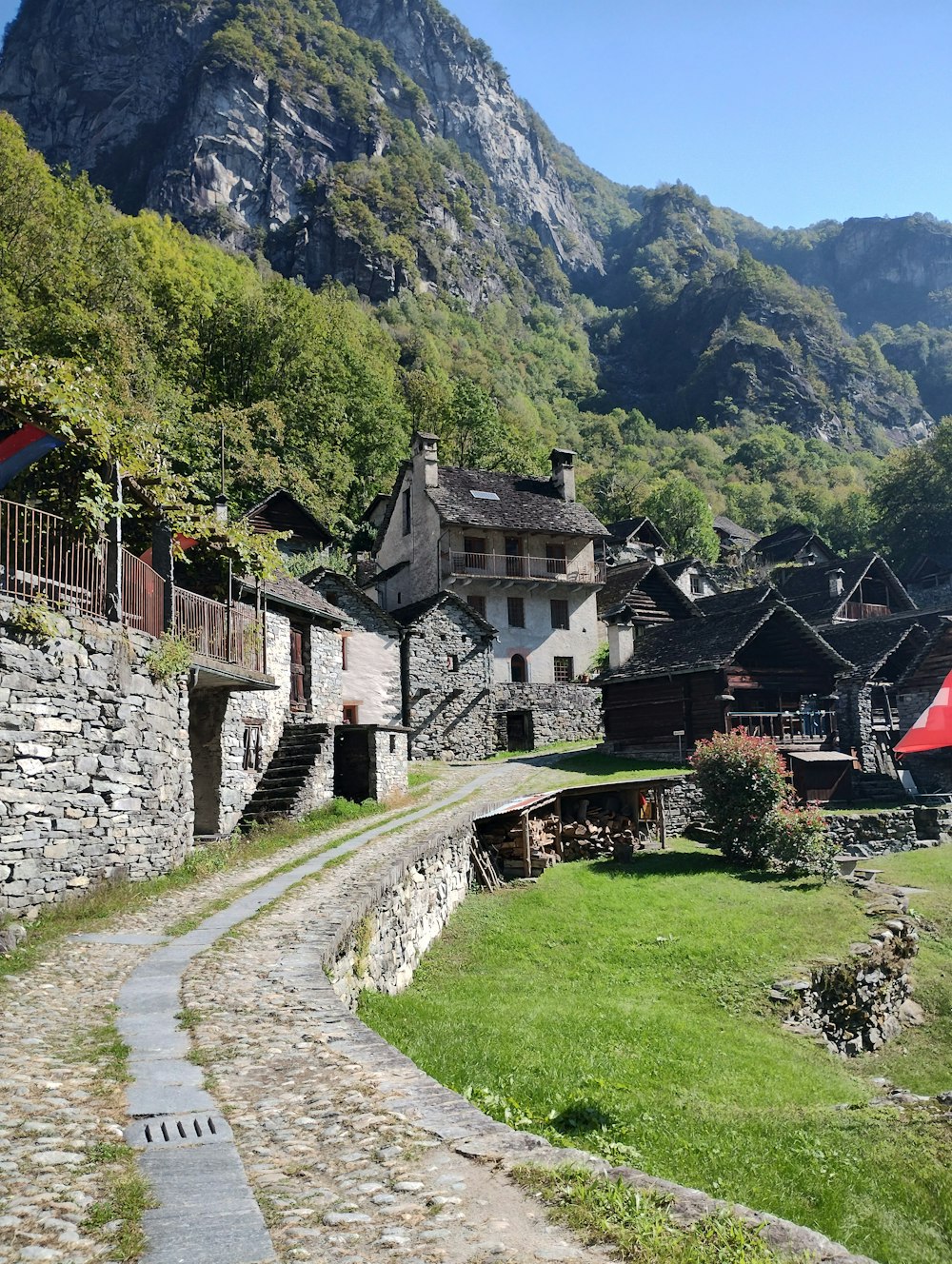 a cobblestone path leading to a village in the mountains