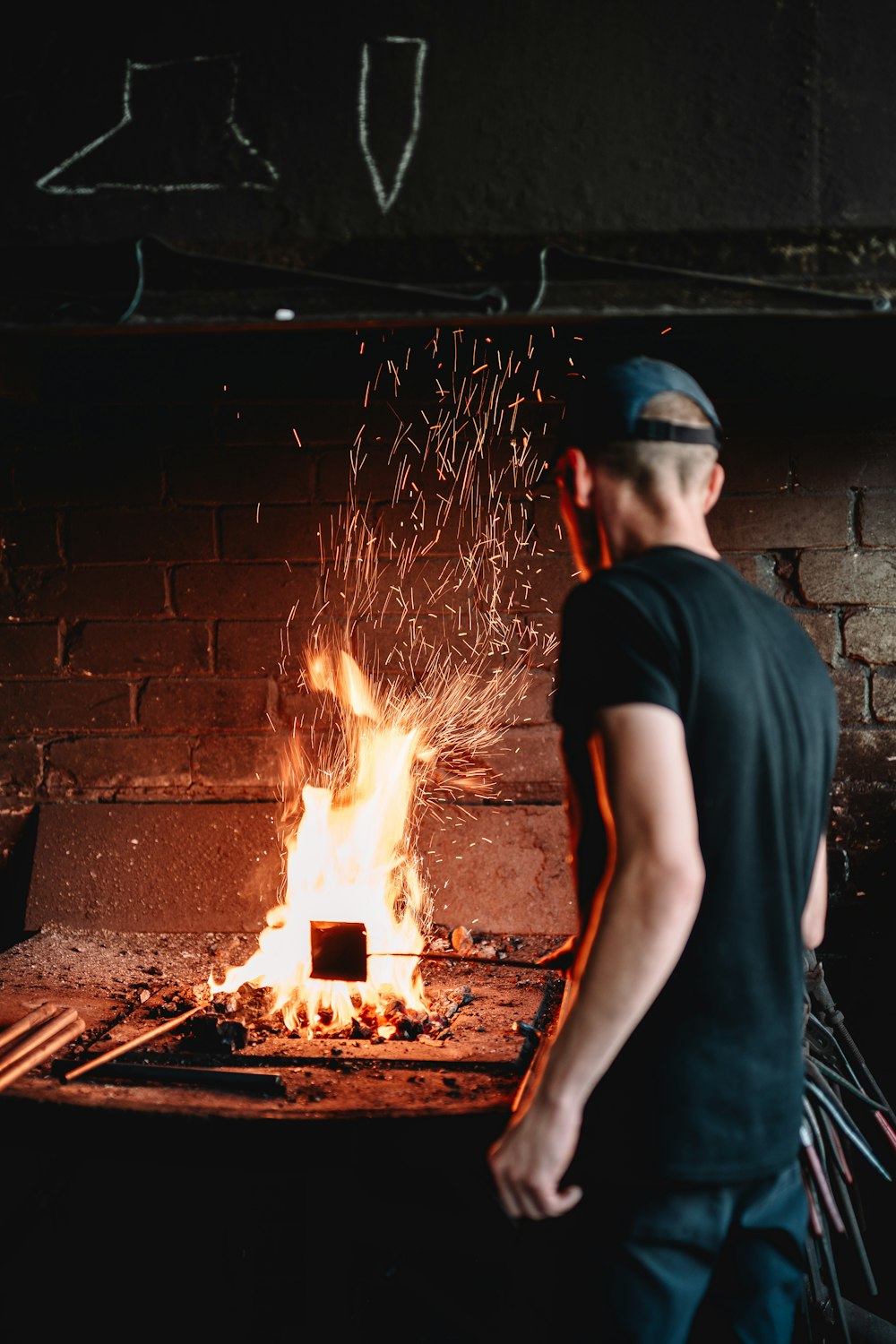 a man standing in front of a fire