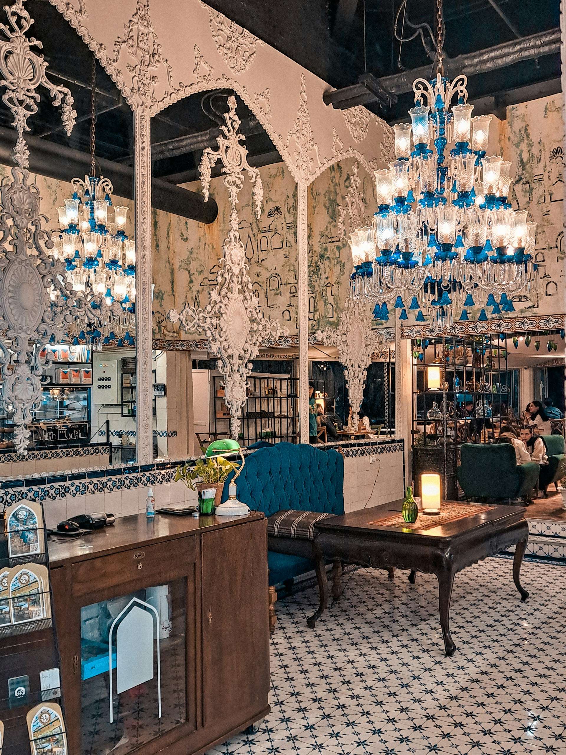 The cozy and sophisticated interior of La Cúpula Azul, showcasing blue and gold accents with soft lighting and artistic decor.