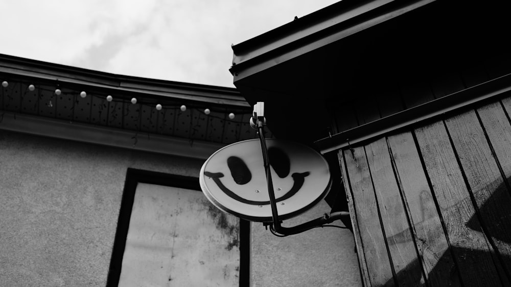 a black and white photo of a smiley face sign