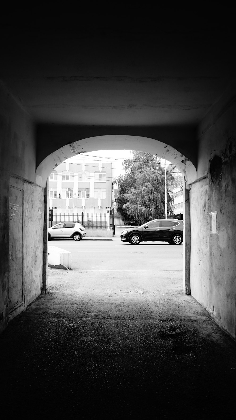 a black and white photo of a car in a tunnel