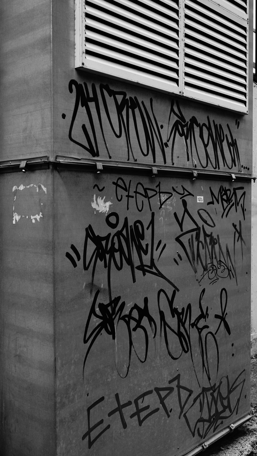 black and white photograph of graffiti on a building
