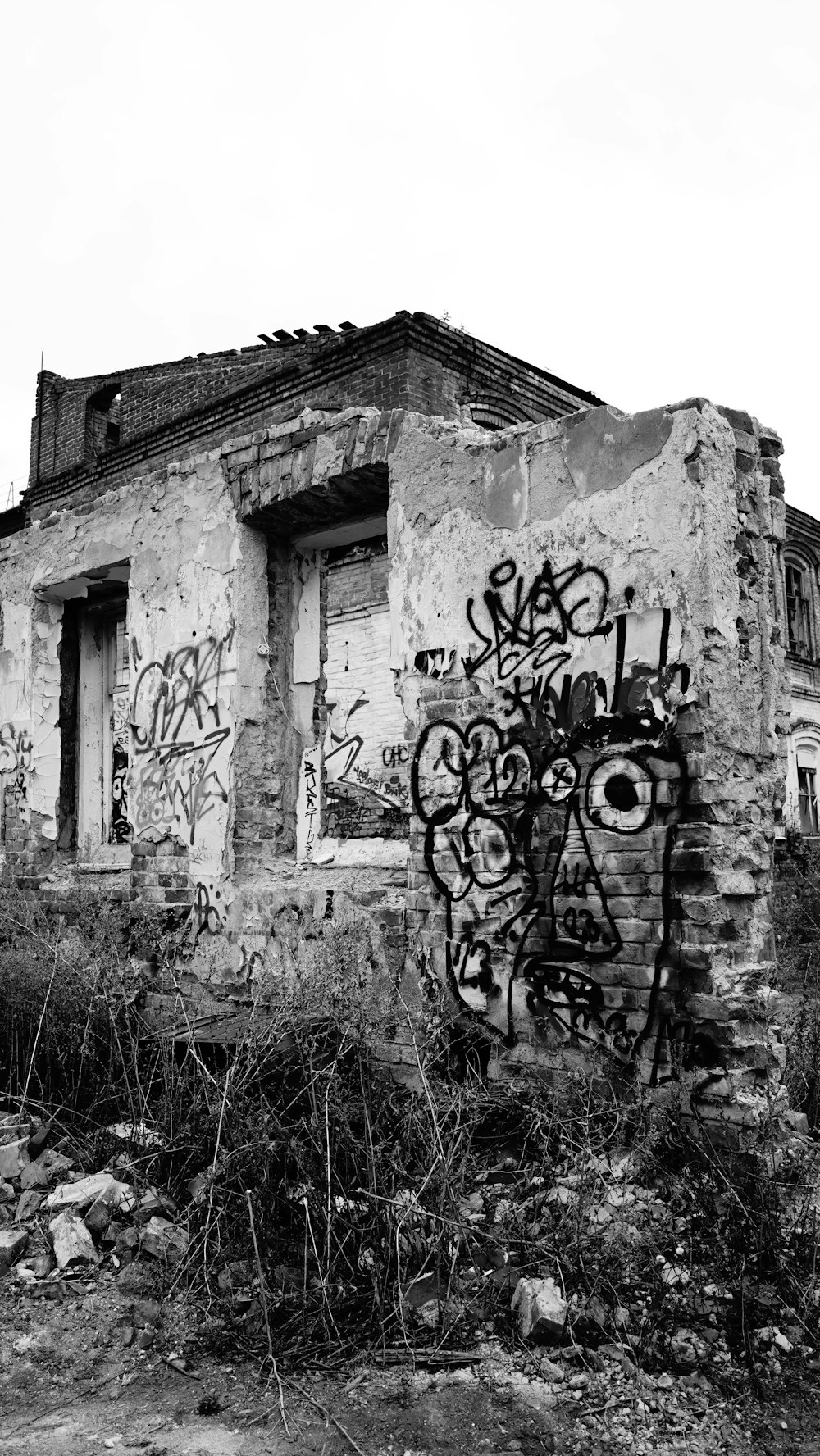 a black and white photo of a building with graffiti on it