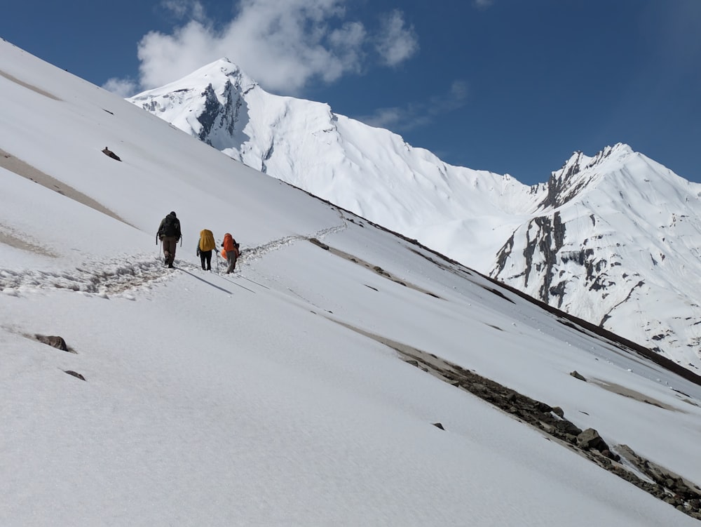 a group of people hiking up a snow covered mountain