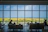 A couple relaxing in a modern, sunlit suite with panoramic views of Cusco’s rooftops.