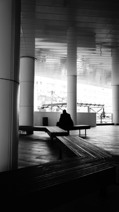 a person sitting on a bench in a building