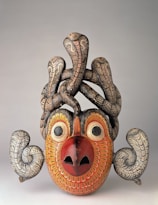 Handcrafted wooden mask with intricate carvings and colorful accents.