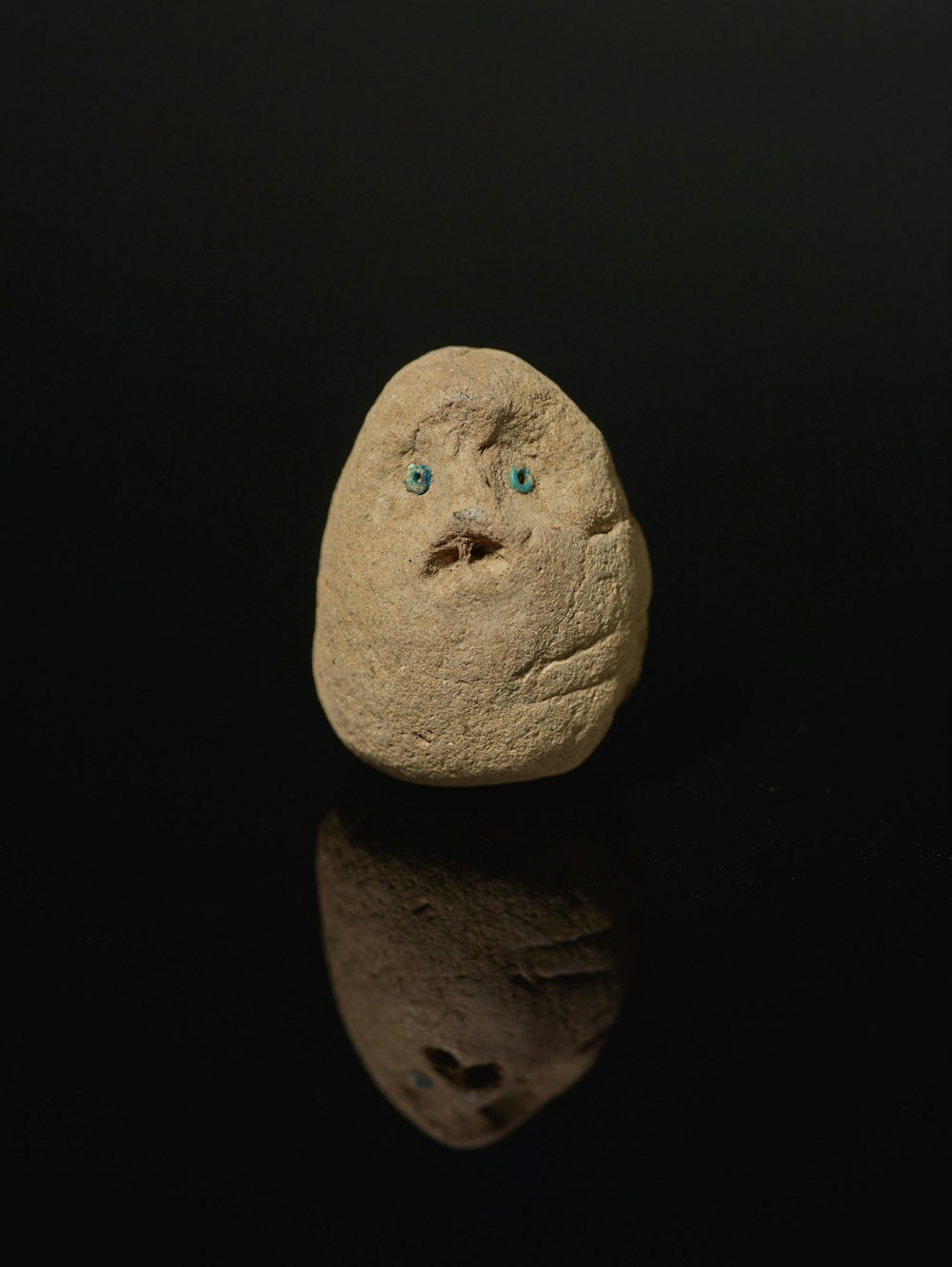 a rock with a face drawn on it