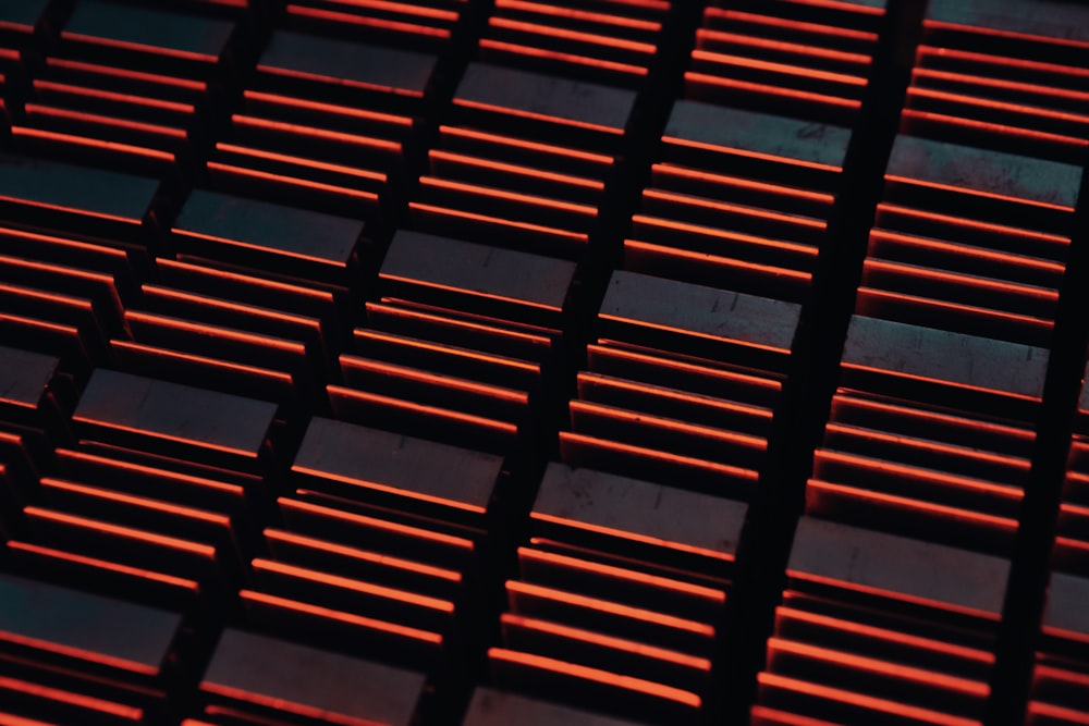a close up of a metal grate with red lights