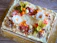 A beautifully decorated custom cake with pastel flowers and smooth frosting in a 4:5 format.