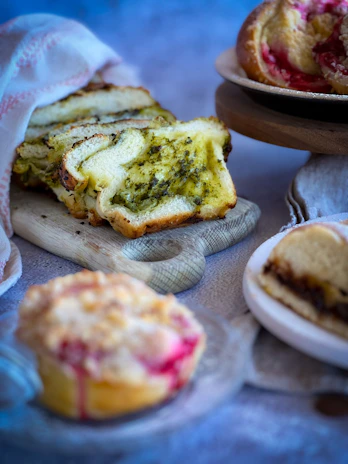 Variety of unlu mamuller including poğaça and other pastries arranged on a wooden board