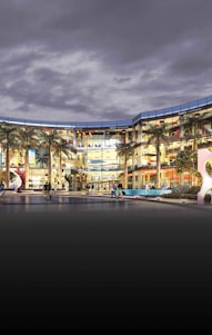 Modern shopping center exterior with people walking nearby