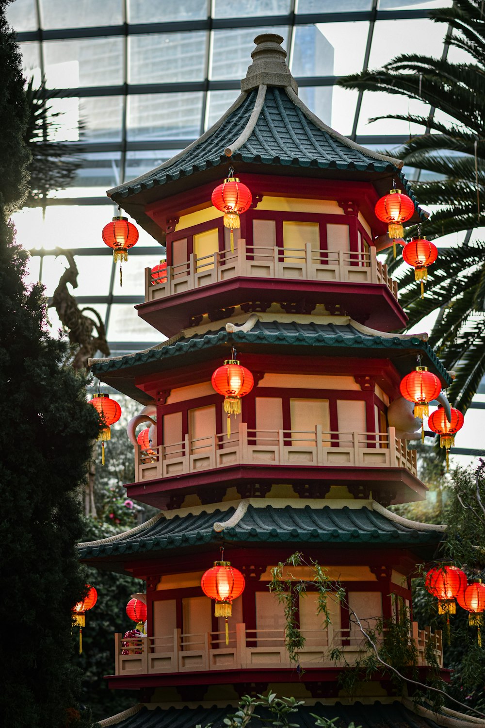 a tall tower with red lanterns hanging from it's sides