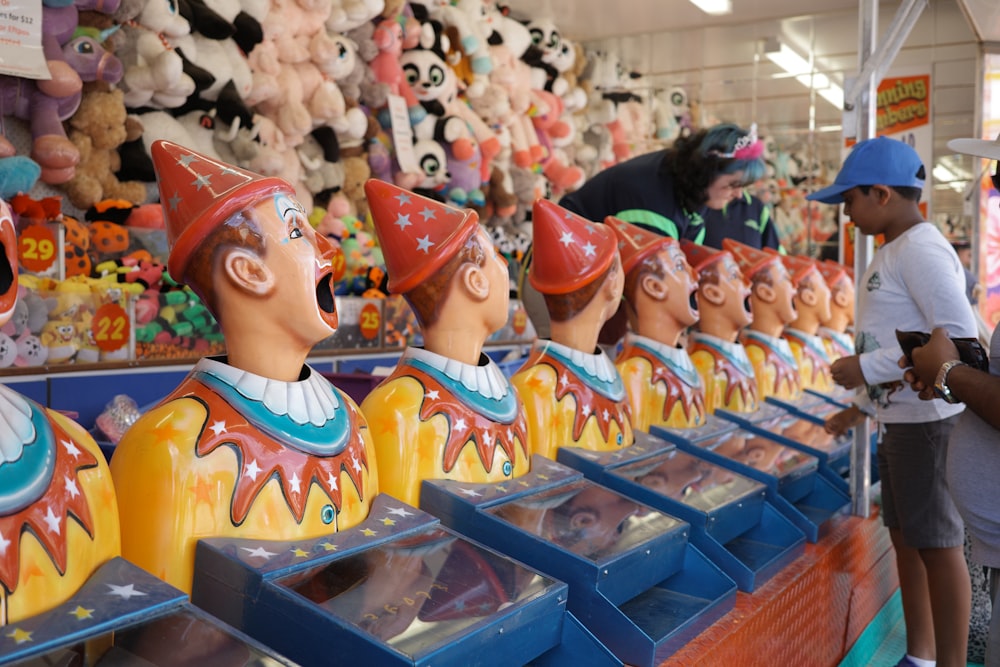 a row of clown heads in a toy store