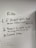 A whiteboard with three handwritten rules. The rules emphasize not touching things that aren't yours, showing respect for staff and others, and using common sense. Drawn with a black marker, the text is surrounded by simple, cloud-like sketches. Additional faint writing is visible around the main text.