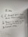 A whiteboard with three handwritten rules. The rules emphasize not touching things that aren't yours, showing respect for staff and others, and using common sense. Drawn with a black marker, the text is surrounded by simple, cloud-like sketches. Additional faint writing is visible around the main text.
