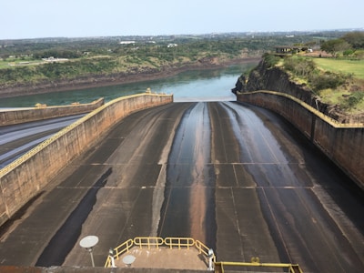 Wide shot of a dam with visible grout injection points along its base.