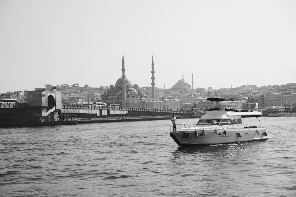 a boat traveling down a river next to a city