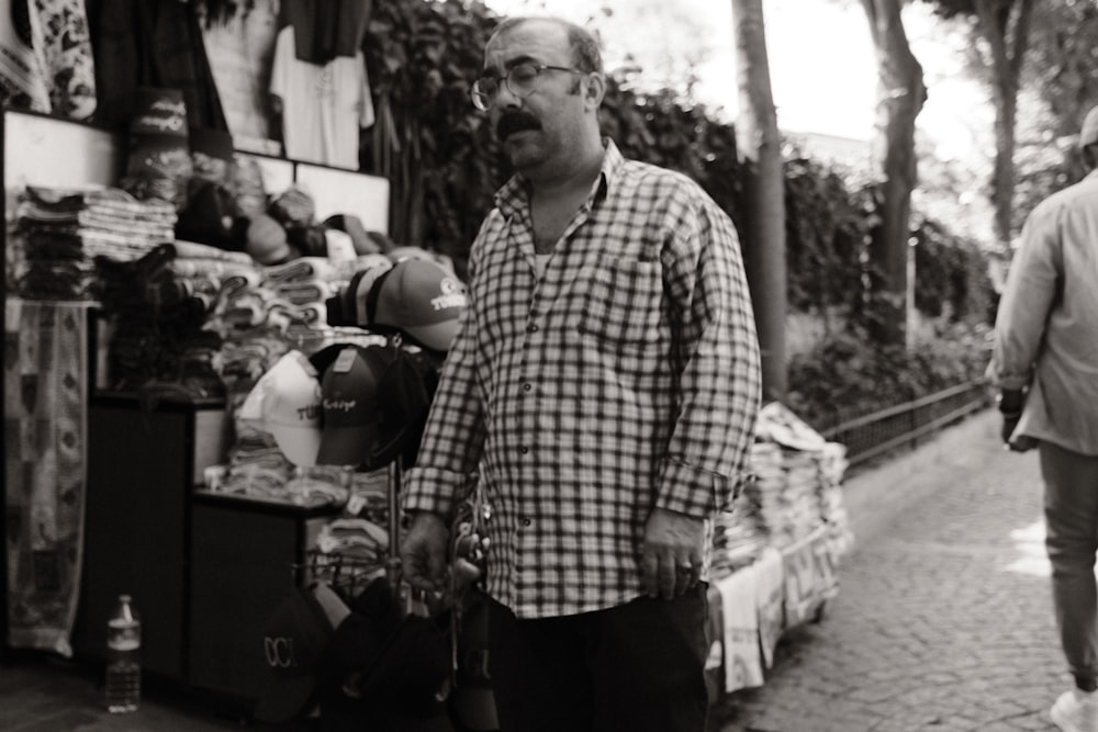 a man walking down a street next to a store