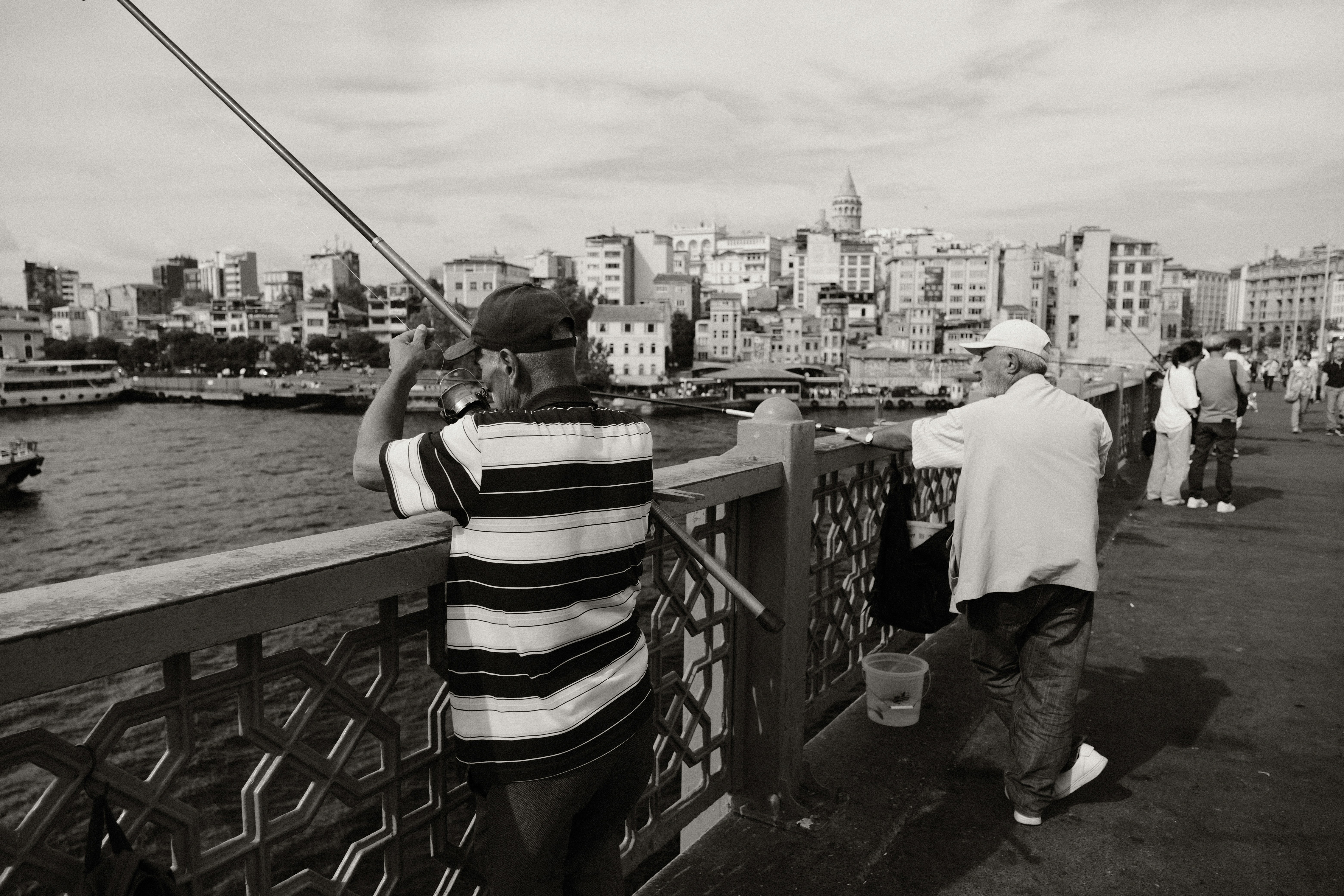 a black and white photo of a man fishing