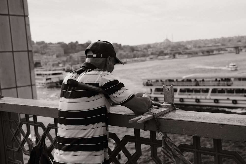 a man standing on a balcony looking over a city