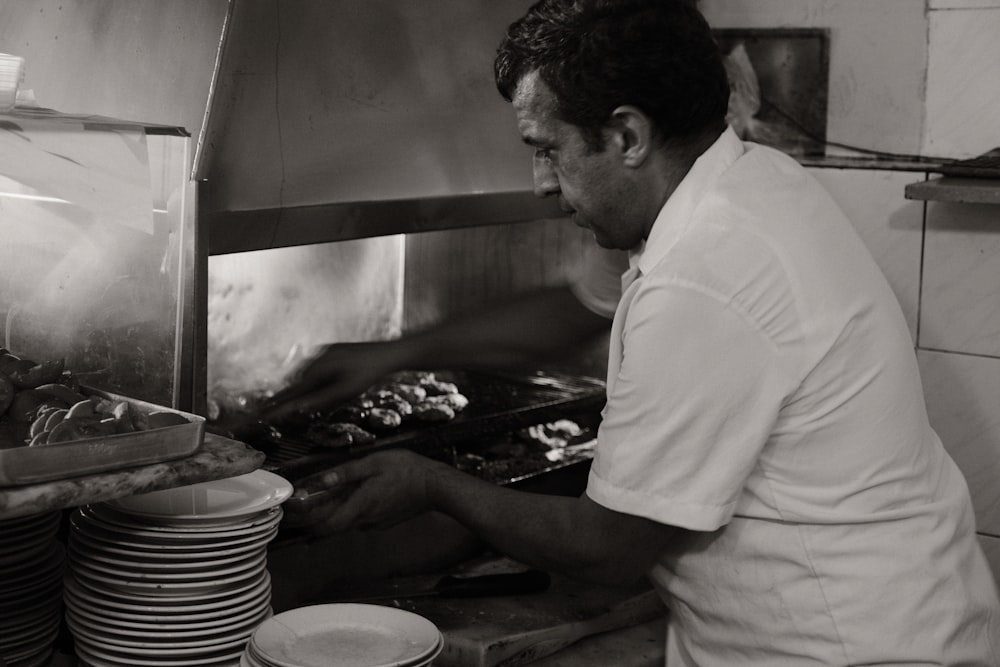 a man in a restaurant kitchen preparing food