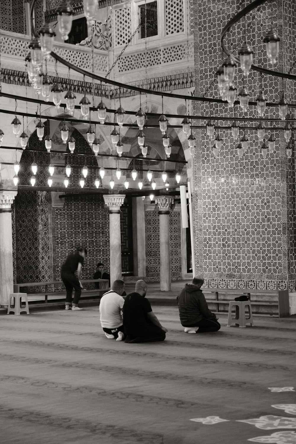 a group of people sitting on the floor of a building