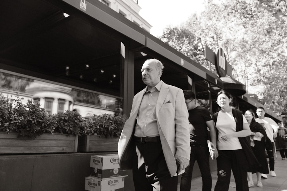 a man in a suit and tie walking down the street