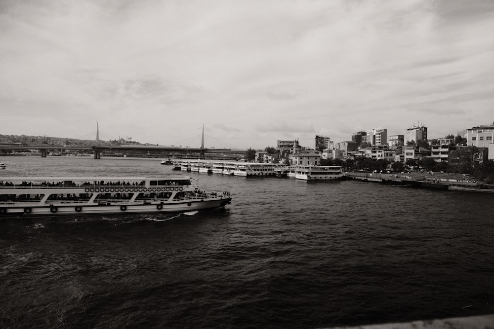 a river filled with lots of boats next to a city