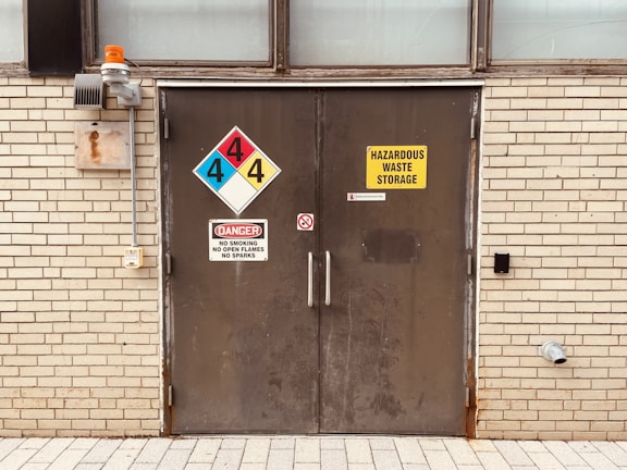 A door with hazardous waste storage sign