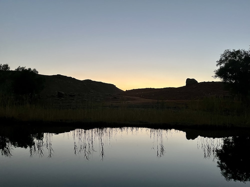 a body of water with a mountain in the background