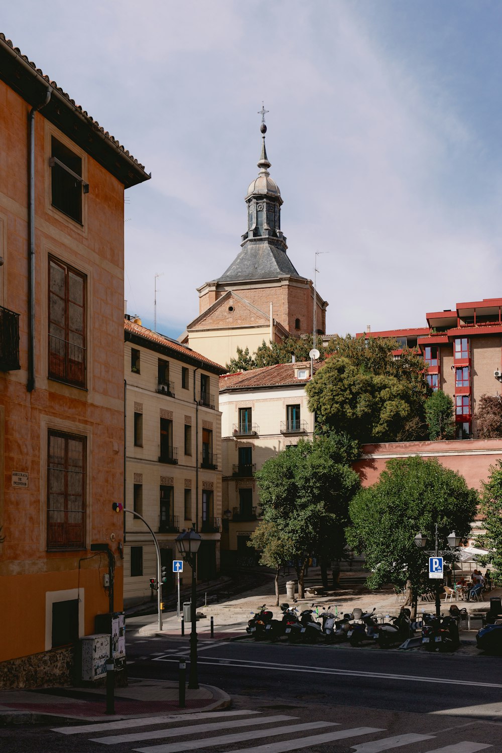 a view of a city street with a clock tower in the background