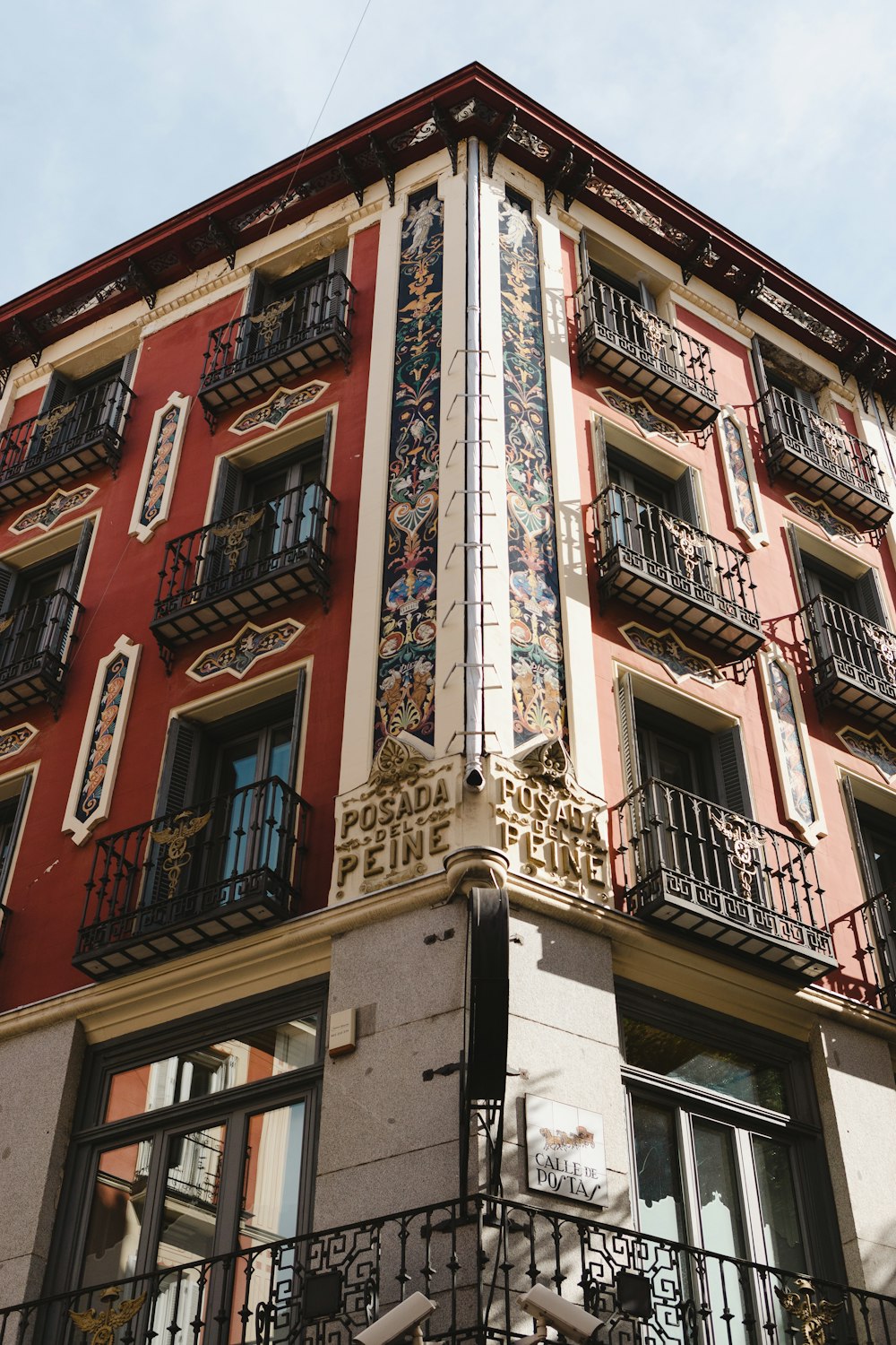 a tall building with balconies on the top of it