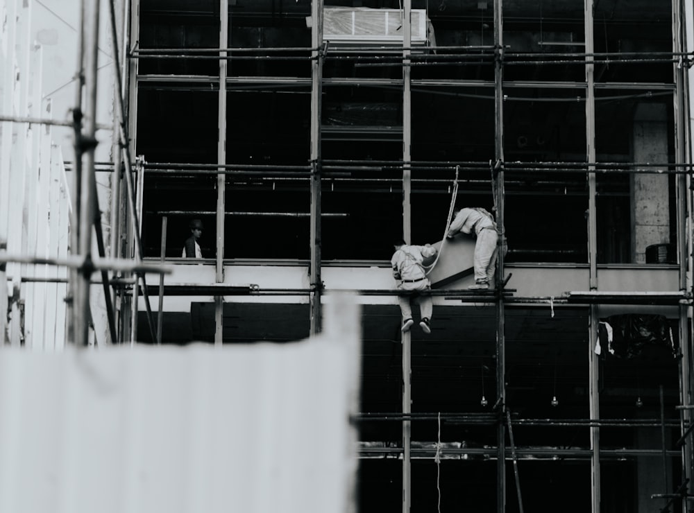 a black and white photo of a building under construction