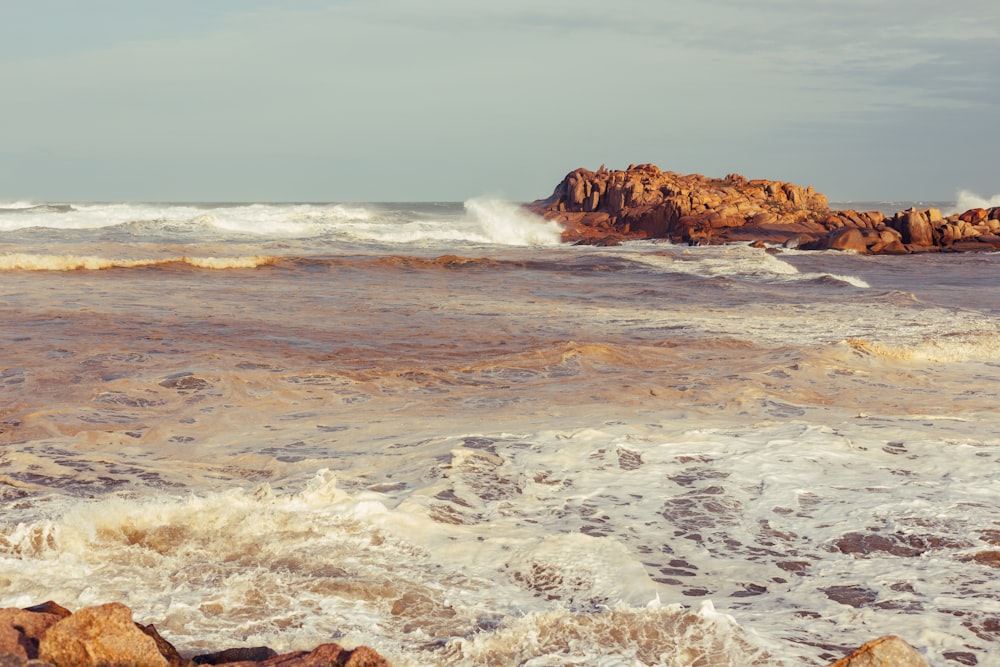 a large body of water next to a rocky shore